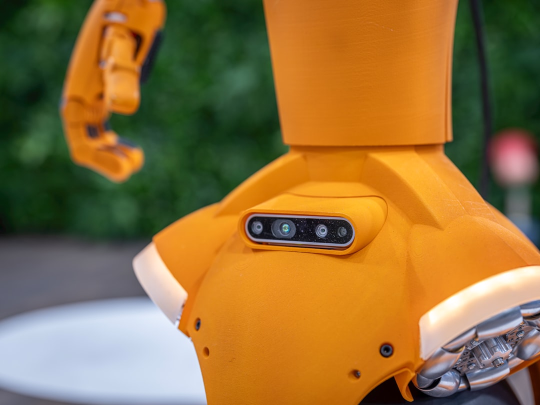 GPT-5.4 AI agent computer use automation - Close-up of an orange robot with a sensor array.