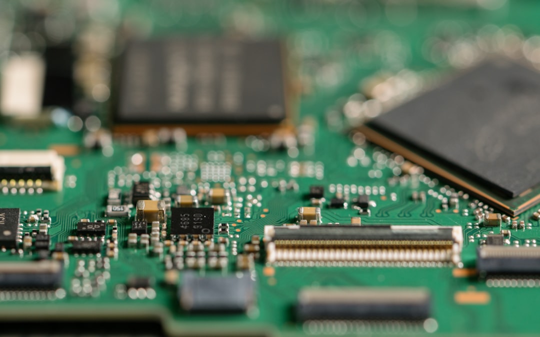 Close-up of a green circuit board with microchips - semiconductor manufacturing technology.