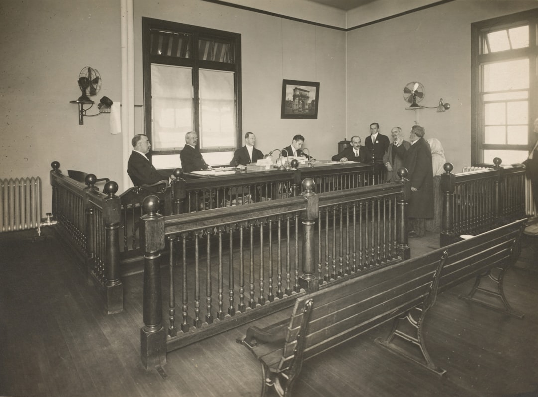 RWA 기관 투자 - a group of men standing around a wooden desk