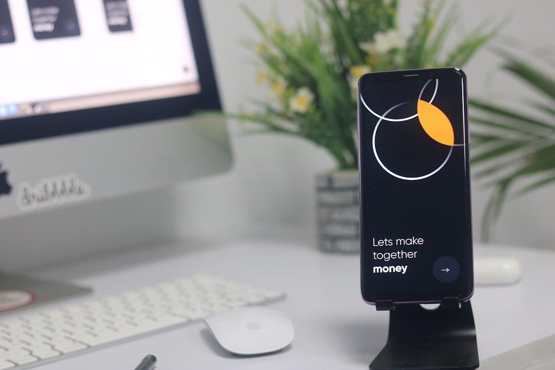 보잉 737 $BA 주가 하락 — a cell phone sitting on top of a desk next to a computer