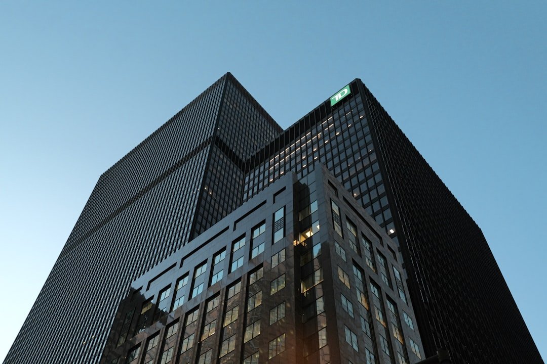 비트코인 ETF 기관 매집 - Modern skyscrapers against a clear blue sky.